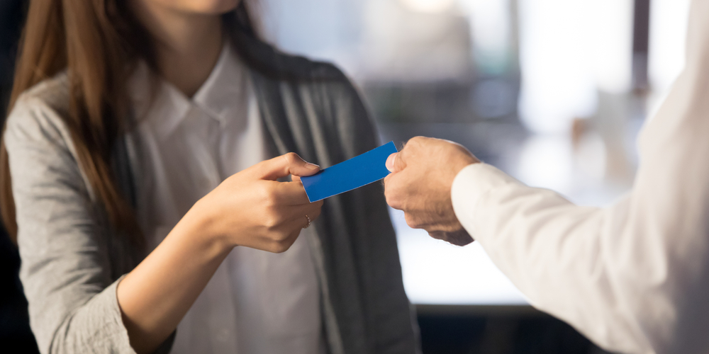 女人递给男人一张名片