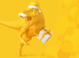 T-rex в шапке Санта-Клауса с подарком в руке, представляющий праздничные расходы 2022 года.