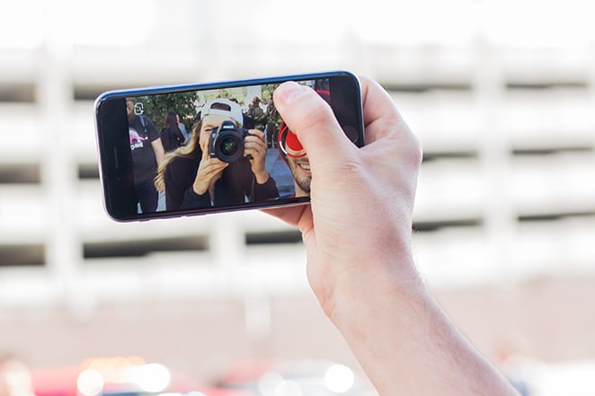 tata letak dengan gambar roda gila di situs meningkatkan konversi penjualan dengan tangan mengambil selfie di telepon orang yang mengambil foto dirinya di layar